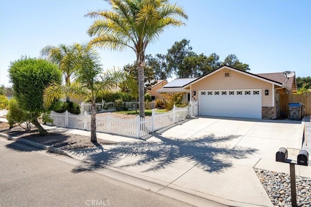 448 Grove Ln, Nipomo, CA 93444 - view of front of home featuring roof mounted solar panels, an attached garage, driveway, and a fenced front yard