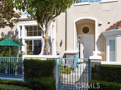 11 Chandon, Newport Coast, CA 92657 - view of front of property with a fenced front yard, stucco siding, and a gate
