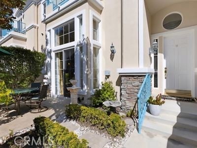 11 Chandon, Newport Coast, CA 92657 - view of exterior entry with a patio area and stucco siding