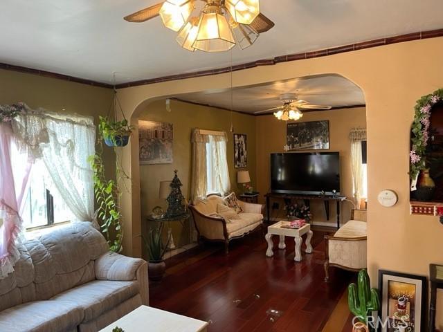 13567 Eldridge Ave, Sylmar, CA 91342 - living area with arched walkways, ceiling fan, and wood finished floors