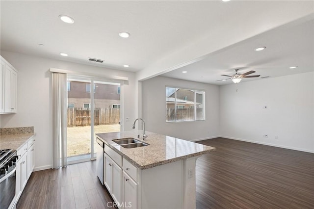 6648 E Yale, Fresno, CA 93727 - kitchen featuring dark wood-style flooring, healthy amount of natural light, white cabinetry, recessed lighting, and light stone counters