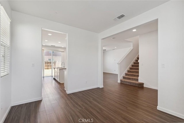 6648 E Yale, Fresno, CA 93727 - unfurnished room featuring dark wood-style floors and stairway
