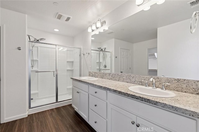 6648 E Yale, Fresno, CA 93727 - bathroom with a stall shower, wood finished floors, and double vanity