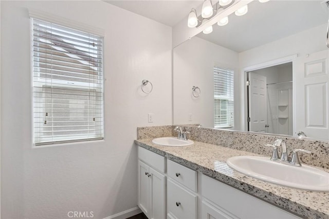 6648 E Yale, Fresno, CA 93727 - bathroom with double vanity, healthy amount of natural light, and a shower