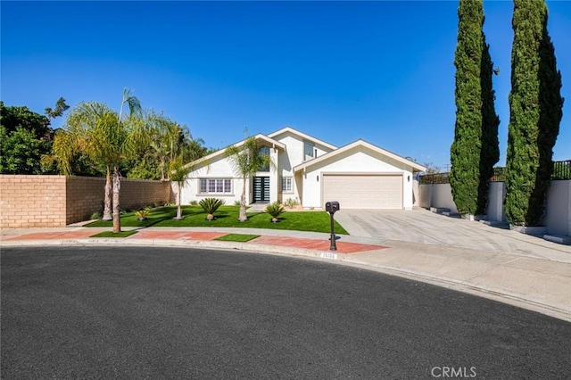 16186 Mount Gist Cir, Fountain Valley, CA 92708 - view of front of house with an attached garage, driveway, and stucco siding