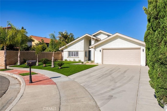 16186 Mount Gist Cir, Fountain Valley, CA 92708 - view of front of property featuring a garage, stucco siding, and driveway