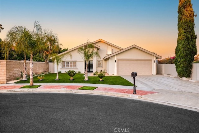 16186 Mount Gist Cir, Fountain Valley, CA 92708 - view of front of house featuring concrete driveway, an attached garage, and stucco siding