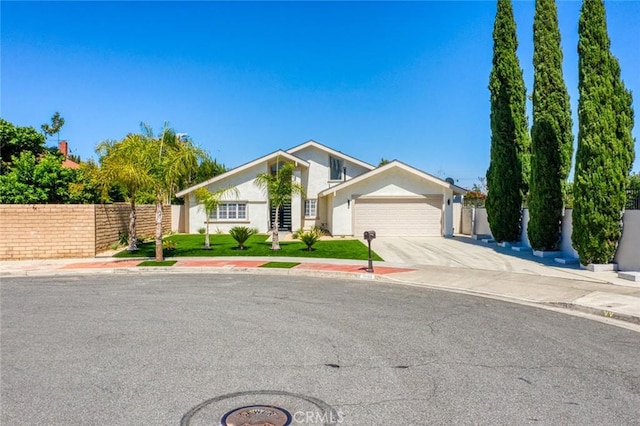 16186 Mount Gist Cir, Fountain Valley, CA 92708 - view of front of house featuring a garage, concrete driveway, and stucco siding