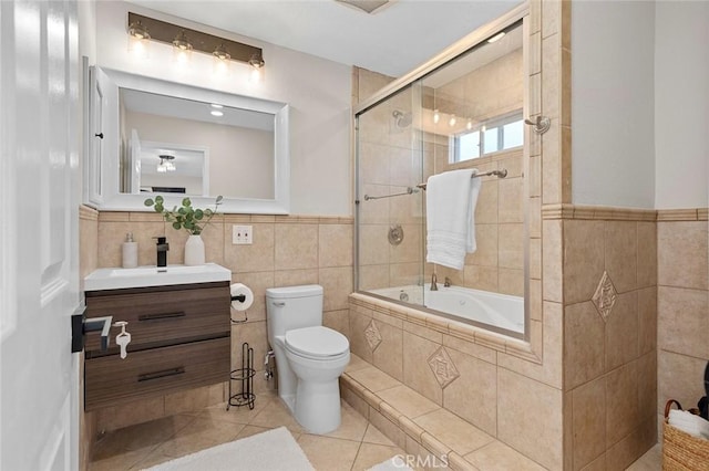 16186 Mount Gist Cir, Fountain Valley, CA 92708 - bathroom with tile walls, vanity, tile patterned floors, tiled shower / bath combo, and wainscoting