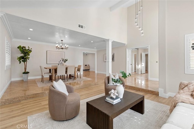 16186 Mount Gist Cir, Fountain Valley, CA 92708 - living room with decorative columns, high vaulted ceiling, recessed lighting, ornamental molding, and a chandelier