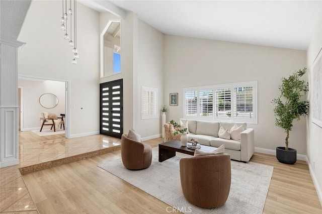 16186 Mount Gist Cir, Fountain Valley, CA 92708 - living room featuring high vaulted ceiling and light wood-style floors