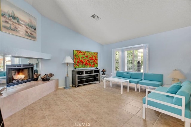 31121 Avenida Ximino, Cathedral City, CA 92234 - tiled living area featuring lofted ceiling, a fireplace, and a textured ceiling