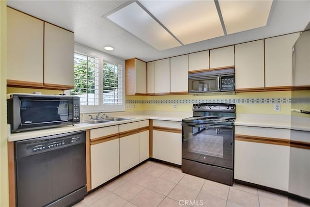 31121 Avenida Ximino, Cathedral City, CA 92234 - kitchen with black appliances, light countertops, backsplash, and light tile patterned floors