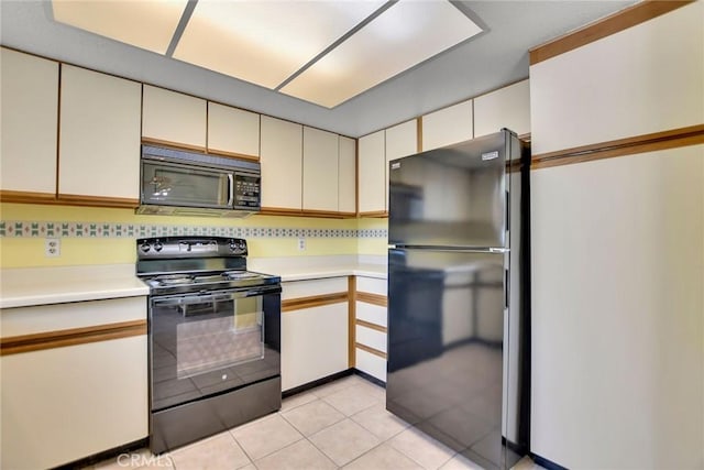 31121 Avenida Ximino, Cathedral City, CA 92234 - kitchen with black appliances, light countertops, light tile patterned floors, tasteful backsplash, and cream cabinets