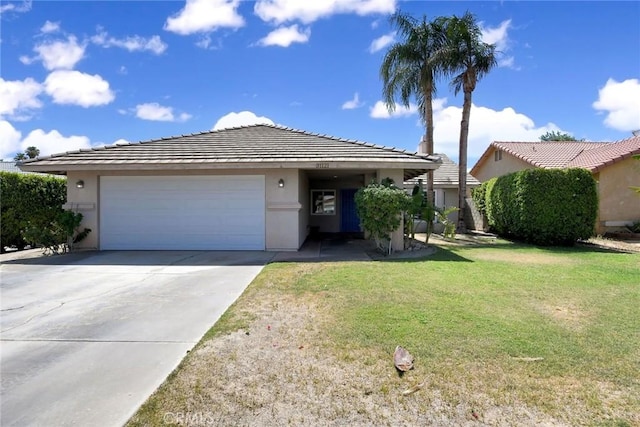 31121 Avenida Ximino, Cathedral City, CA 92234 - view of front of house with stucco siding, a garage, driveway, and a front lawn