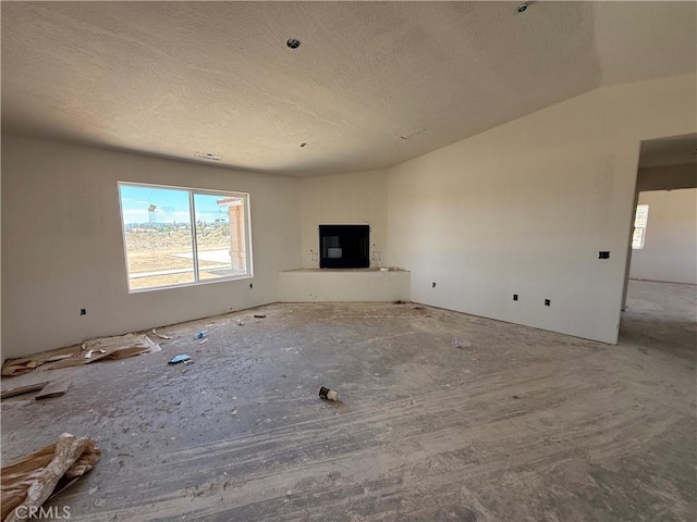 9570 Mescalero Rd, Phelan, CA 92371 - unfurnished living room featuring a textured ceiling