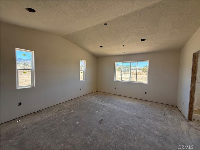 9570 Mescalero Rd, Phelan, CA 92371 - unfurnished room with a textured ceiling and lofted ceiling