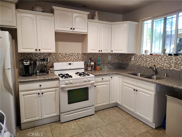 10815 Gorman Ave, Los Angeles, CA 90059 - kitchen featuring white appliances, tasteful backsplash, light tile patterned floors, white cabinetry, and light stone counters