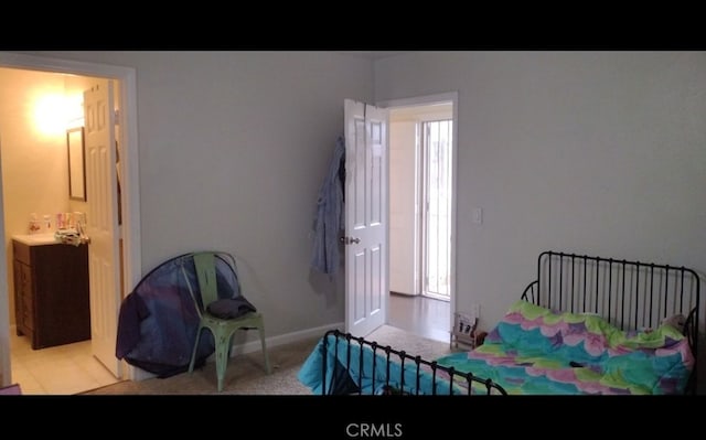 10815 Gorman Ave, Los Angeles, CA 90059 - carpeted bedroom featuring baseboards and ensuite bath