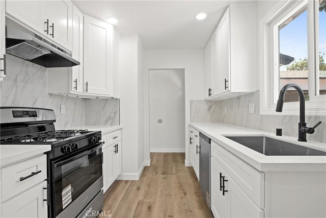 1132 Broadmoor Ave, La Puente, CA 91744 - kitchen featuring range with gas stovetop, under cabinet range hood, backsplash, stainless steel dishwasher, and recessed lighting