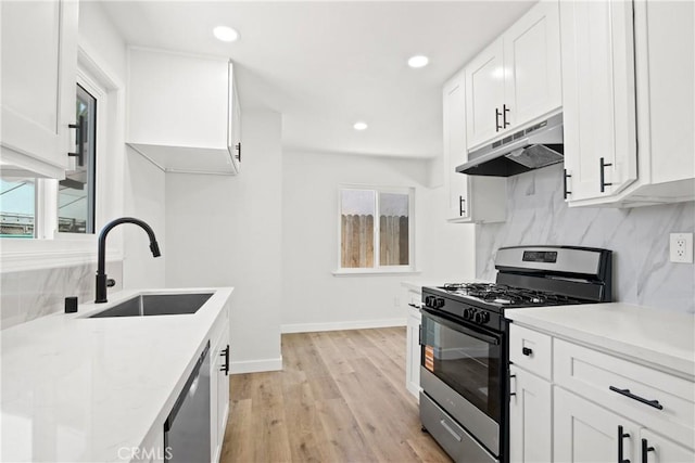 1132 Broadmoor Ave, La Puente, CA 91744 - kitchen featuring gas range oven, under cabinet range hood, dishwasher, plenty of natural light, and recessed lighting