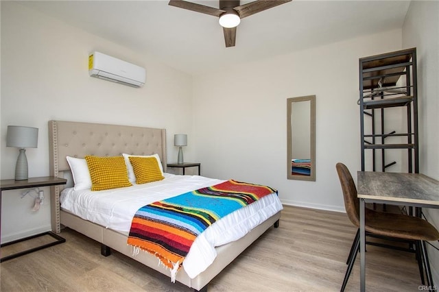 4574 Avenida Del Sol, Joshua Tree, CA 92252 - bedroom featuring a wall unit AC, wood finished floors, and a ceiling fan