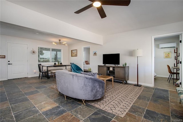 4574 Avenida Del Sol, Joshua Tree, CA 92252 - living room with stone tile flooring, a wall mounted air conditioner, a chandelier, and a ceiling fan