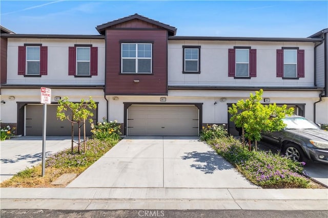 300 Farmhouse Dr Unit 3, Simi Valley, CA 93065 - view of property featuring a garage, driveway, and stucco siding
