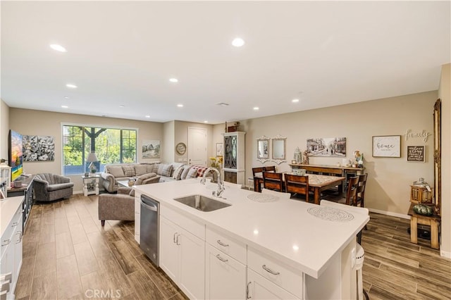300 Farmhouse Dr Unit 3, Simi Valley, CA 93065 - kitchen featuring stainless steel dishwasher, a center island with sink, open floor plan, wood finished floors, and recessed lighting