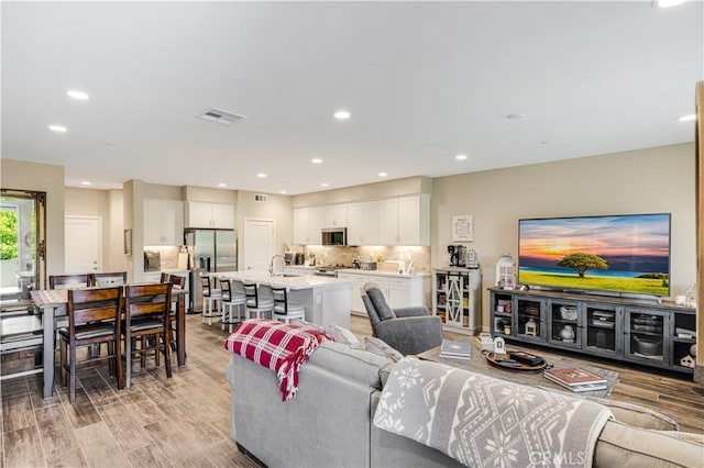 300 Farmhouse Dr Unit 3, Simi Valley, CA 93065 - living area featuring light wood finished floors and recessed lighting