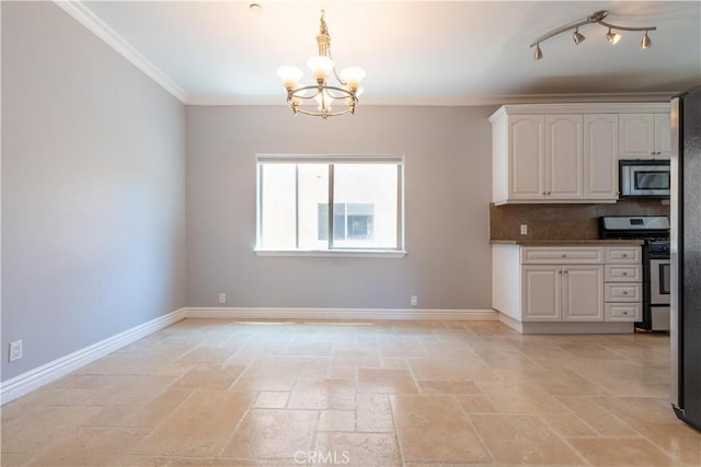 11253 Peach Grove St Unit 106, North Hollywood, CA 91601 - kitchen with appliances with stainless steel finishes, stone tile flooring, a chandelier, white cabinets, and crown molding