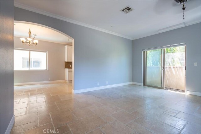 11253 Peach Grove St Unit 106, North Hollywood, CA 91601 - unfurnished room featuring stone tile flooring, arched walkways, crown molding, and a chandelier