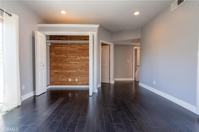11253 Peach Grove St Unit 106, North Hollywood, CA 91601 - unfurnished bedroom featuring wood finished floors, wooden walls, recessed lighting, and a closet