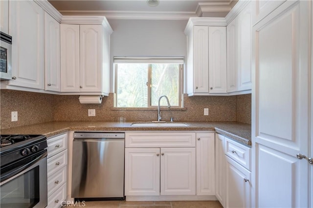 11253 Peach Grove St Unit 106, North Hollywood, CA 91601 - kitchen with appliances with stainless steel finishes, crown molding, white cabinets, backsplash, and light countertops
