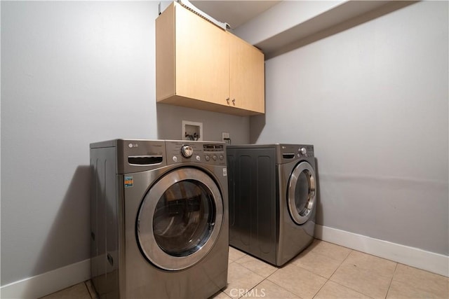11253 Peach Grove St Unit 106, North Hollywood, CA 91601 - laundry area with cabinet space, independent washer and dryer, and light tile patterned flooring