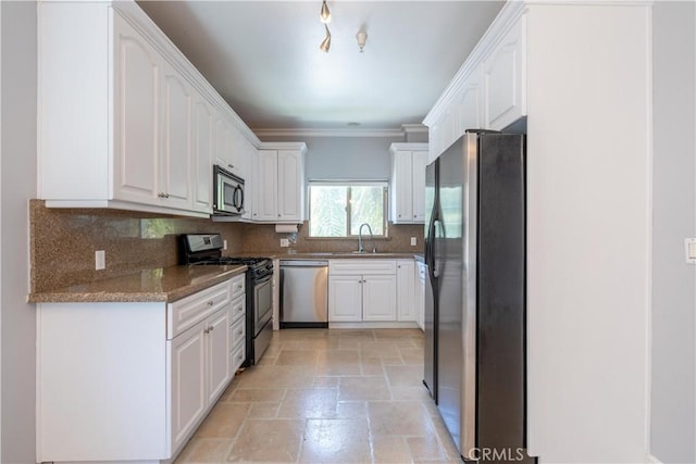 11253 Peach Grove St Unit 106, North Hollywood, CA 91601 - kitchen featuring appliances with stainless steel finishes, stone tile flooring, decorative backsplash, white cabinets, and ornamental molding