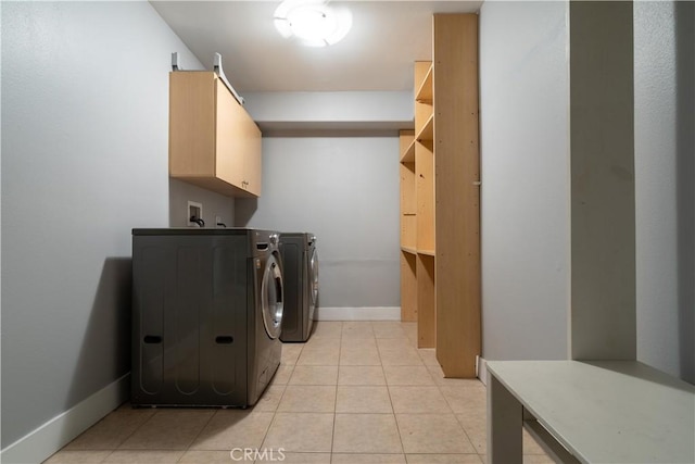 11253 Peach Grove St Unit 106, North Hollywood, CA 91601 - washroom featuring cabinet space, washing machine and dryer, and light tile patterned flooring