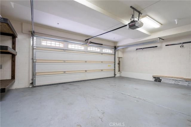 11253 Peach Grove St Unit 106, North Hollywood, CA 91601 - garage featuring a garage door opener and concrete block wall