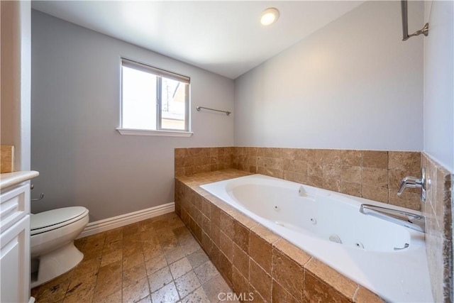 11253 Peach Grove St Unit 106, North Hollywood, CA 91601 - full bath with a tub with jets, vanity, and stone finish floors