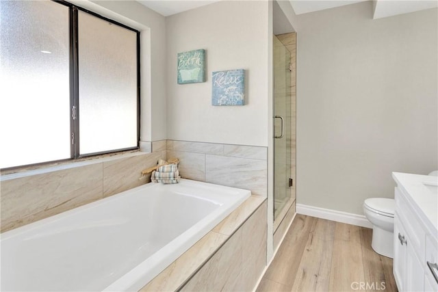 11969 Pinon Ave, Hesperia, CA 92345 - bathroom with vanity, a shower stall, a garden tub, and wood finished floors