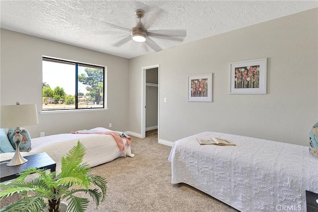 11969 Pinon Ave, Hesperia, CA 92345 - bedroom featuring carpet floors, a textured ceiling, a spacious closet, and ceiling fan