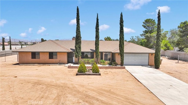 11969 Pinon Ave, Hesperia, CA 92345 - view of front facade with a garage, driveway, and a chimney
