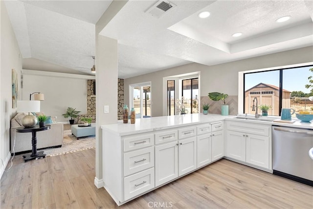 11969 Pinon Ave, Hesperia, CA 92345 - kitchen with dishwasher, a textured ceiling, light wood-style floors, white cabinets, and light countertops