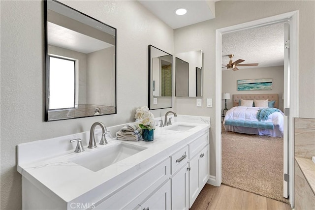 11969 Pinon Ave, Hesperia, CA 92345 - ensuite bathroom featuring double vanity, wood finished floors, and ceiling fan