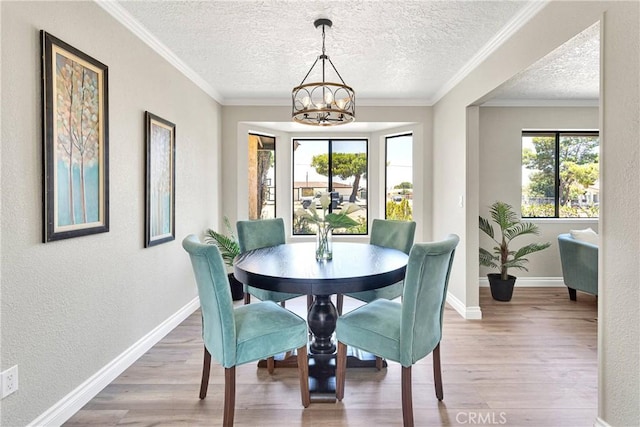 11969 Pinon Ave, Hesperia, CA 92345 - dining space featuring a chandelier, wood finished floors, a textured ceiling, a textured wall, and crown molding