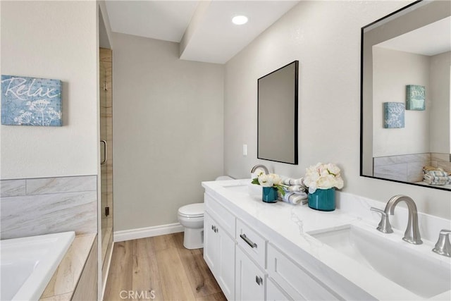 11969 Pinon Ave, Hesperia, CA 92345 - full bathroom featuring double vanity, a shower stall, a garden tub, and wood finished floors