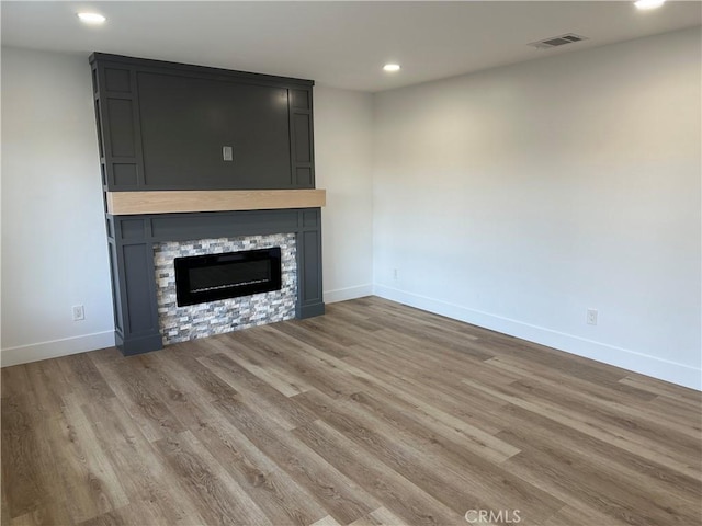 632 Truly Unit 634, Vista, CA 92084 - unfurnished living room with recessed lighting, a stone fireplace, and wood finished floors