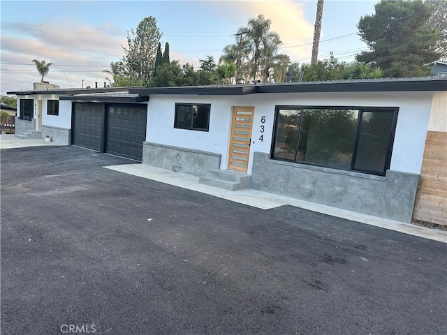 632 Truly Unit 634, Vista, CA 92084 - view of front of property with stucco siding, an attached garage, and asphalt driveway