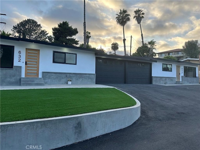 632 Truly Unit 634, Vista, CA 92084 - view of front of home featuring entry steps, a garage, a front yard, and stucco siding