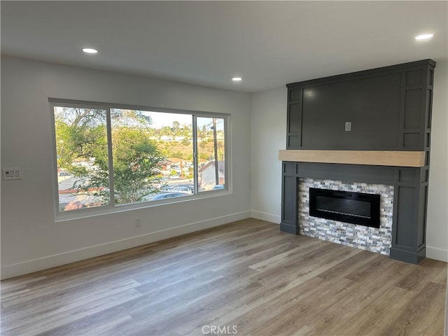 632 Truly Unit 634, Vista, CA 92084 - unfurnished living room with a large fireplace, light wood-style floors, and recessed lighting